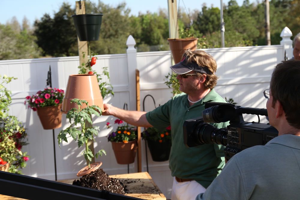 Image of a man watering plants for a commercial. Do You Need a Marketing Video?